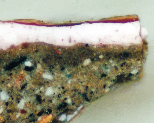 Sezione stratigrafica lucida di un frammento di strato pittorico al microscopio<br>Dipinto ad olio su tela raff.: Adorazione dei Pastori